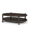 Three-quarter perspective highlighting the tiered oval design and the smooth rounded legs that extend through the tabletop