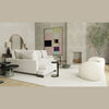 Lifestyle shot of the Rookie table styled in a spacious modern living room with neutral tones and curved contemporary seating