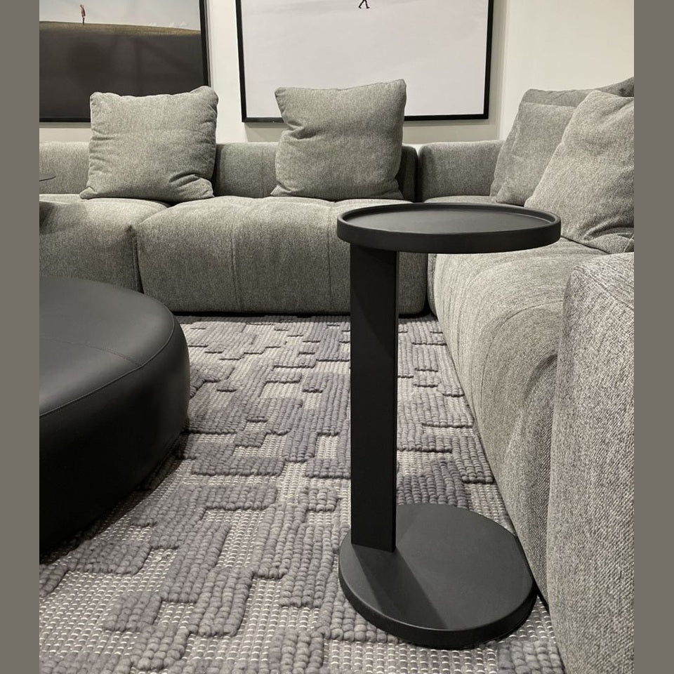 Front view of the Rookie end table featuring a minimalist black metal C-frame design with a slim circular top and matching base