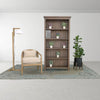 The Rosa chair positioned in a bright reading nook next to a wooden bookshelf