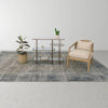 A wide shot showing the Rosa chair as part of a minimalist office or lounge area