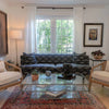 Two Rosa chairs arranged in a formal living room next to a blue patterned sofa