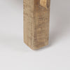 Extreme close-up of a table leg showcasing the substantial solid wood build and natural imperfections