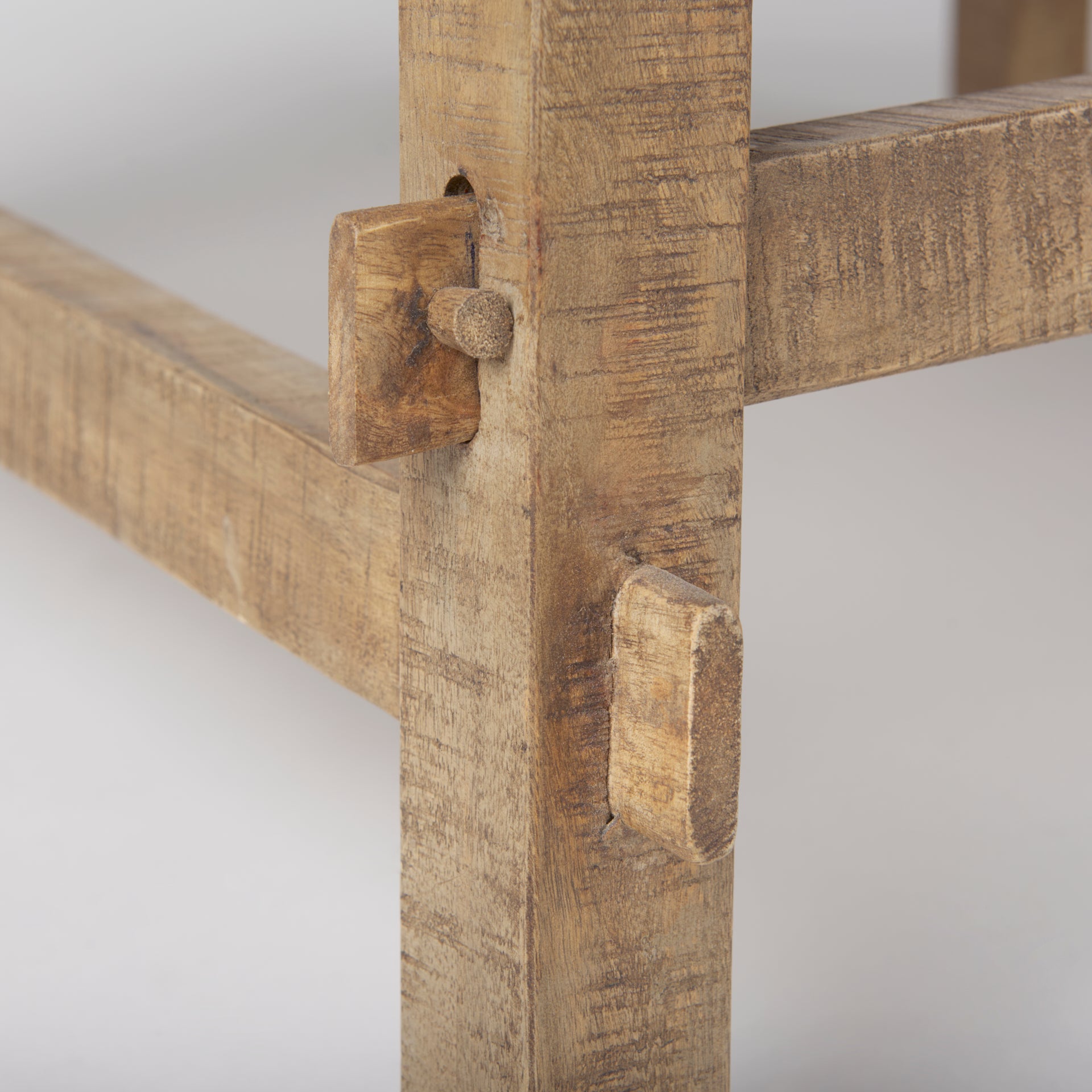 Detailed view of the handcrafted mortise and tenon joinery on the trestle base legs