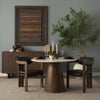 Alternate lifestyle shot showcasing the table paired with dark wood furniture and natural greenery for a warm, transitional look