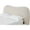 Close-up shot focusing on the plush wave-like silhouette of the headboard and the high-quality tactile chenille upholstery