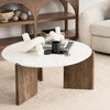Close-up lifestyle shot of the Rumer marble coffee table styled with decorative objects on a neutral area rug