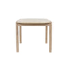 Straight-on side profile view emphasizing the slim tabletop depth and the modern tapered leg design in light oak