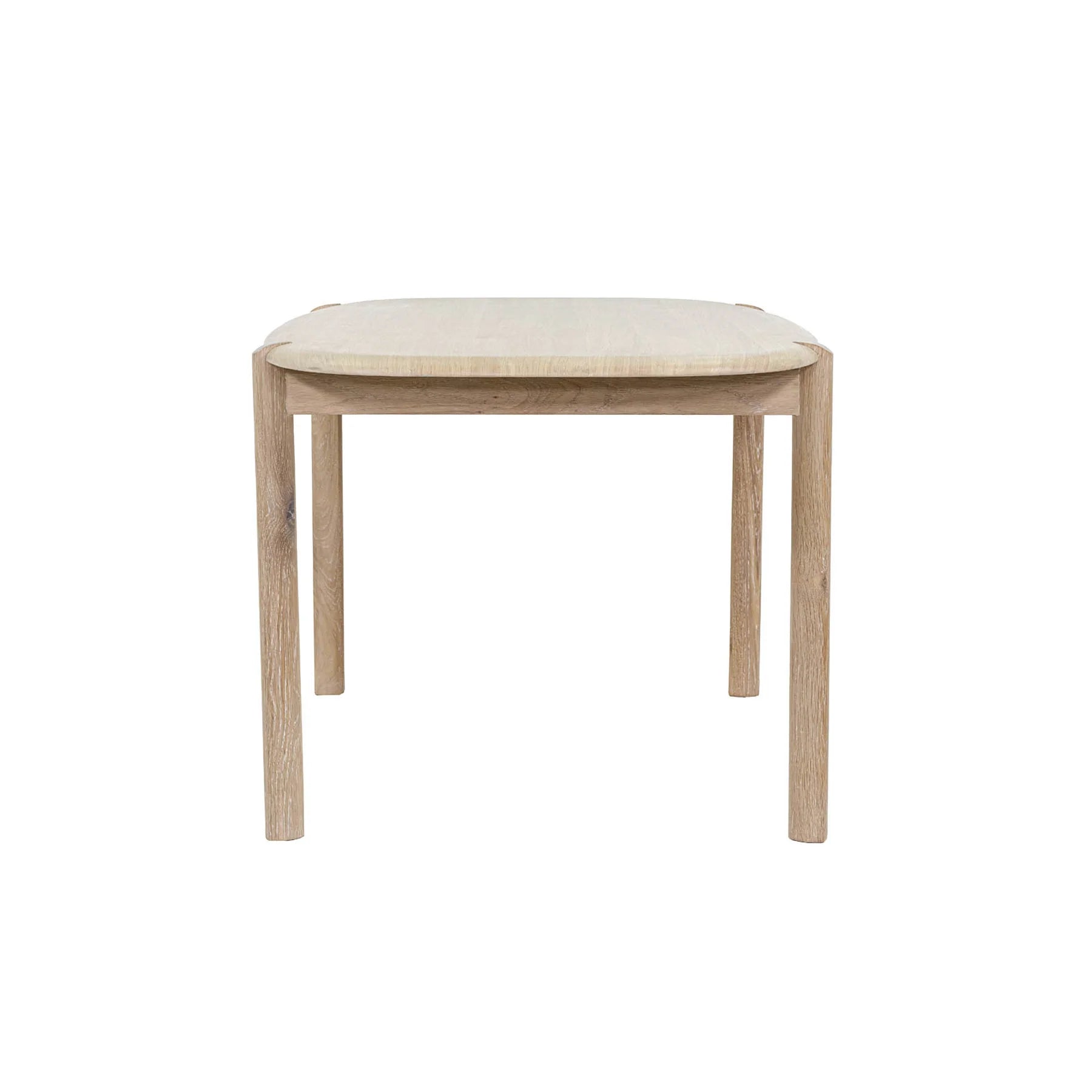 Front view of the Runway 62-inch dining table in a light oak finish featuring rounded edges and a minimalist rectangular silhouette