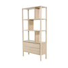 Three-quarter perspective view of the Runway bookcase in light oak featuring an asymmetrical open-shelf design and two wide base storage drawers