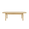 Front view of the Runway coffee table in light oak featuring a thick rectangular top and two substantial block pedestal legs