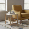 Lifestyle shot of the Runway side table styled next to a yellow armchair with books and decor to demonstrate scale