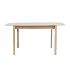 Front view of the Runway 62-inch dining table in a light oak finish featuring rounded edges and a minimalist rectangular silhouette
