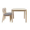 chairs-side-perspective	Side perspective lifestyle shot showcasing the table paired with two neutral upholstered chairs against a clean white background