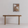 Three-quarter perspective view showcasing the textured reclaimed wood finish and sturdy architectural frame of the Monterey console