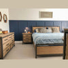 Studio lifestyle shot featuring the Irondale dresser styled with a contemporary lamp and decorative accents against a navy accent wall