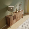 High-angle lifestyle perspective highlighting the scale of the sideboard and the unique textures of the hand-carved panels