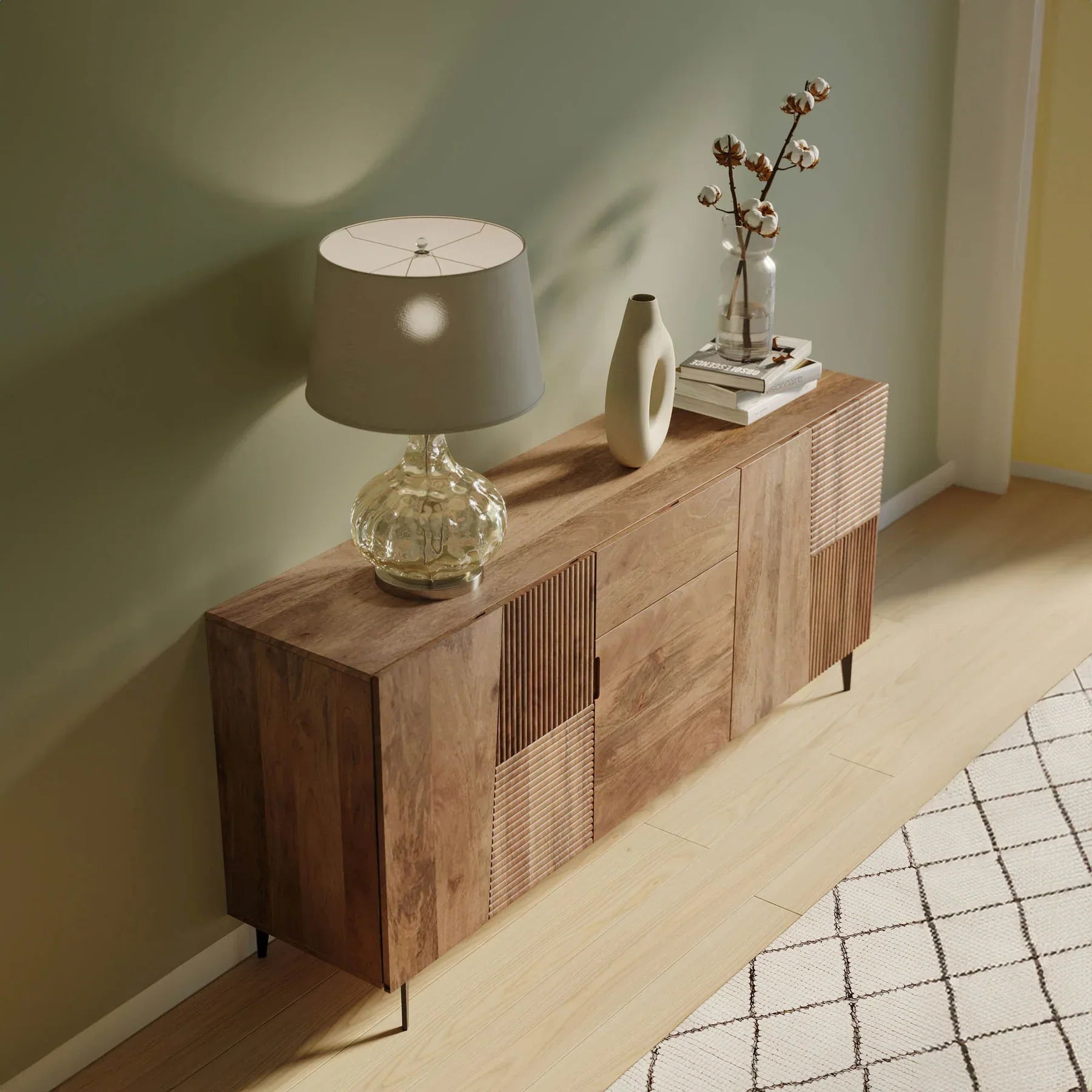 Front view of the Peyton sideboard featuring natural mango wood construction with unique geometric carved door panels and black metal legs