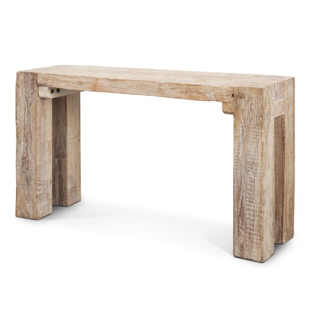 Three-quarter perspective view highlighting the thick block legs and heavy-set architectural frame of the whitewashed wood table