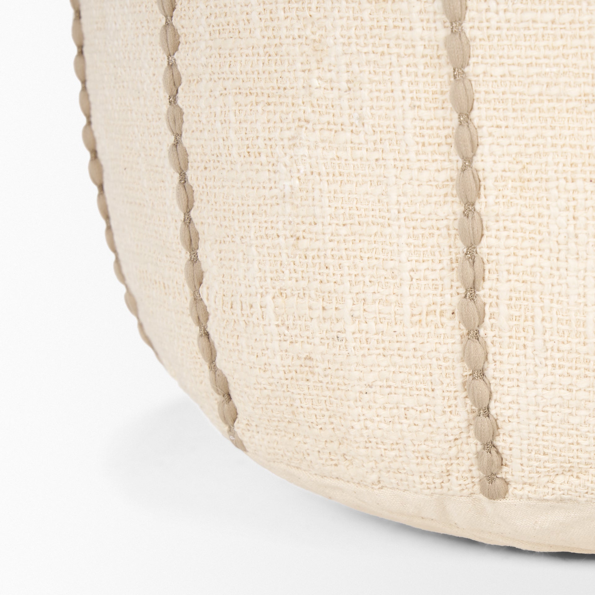 Front view of the Sachi round pouf in beige textured fabric with decorative vertical brown stitching creating a ribbed effect