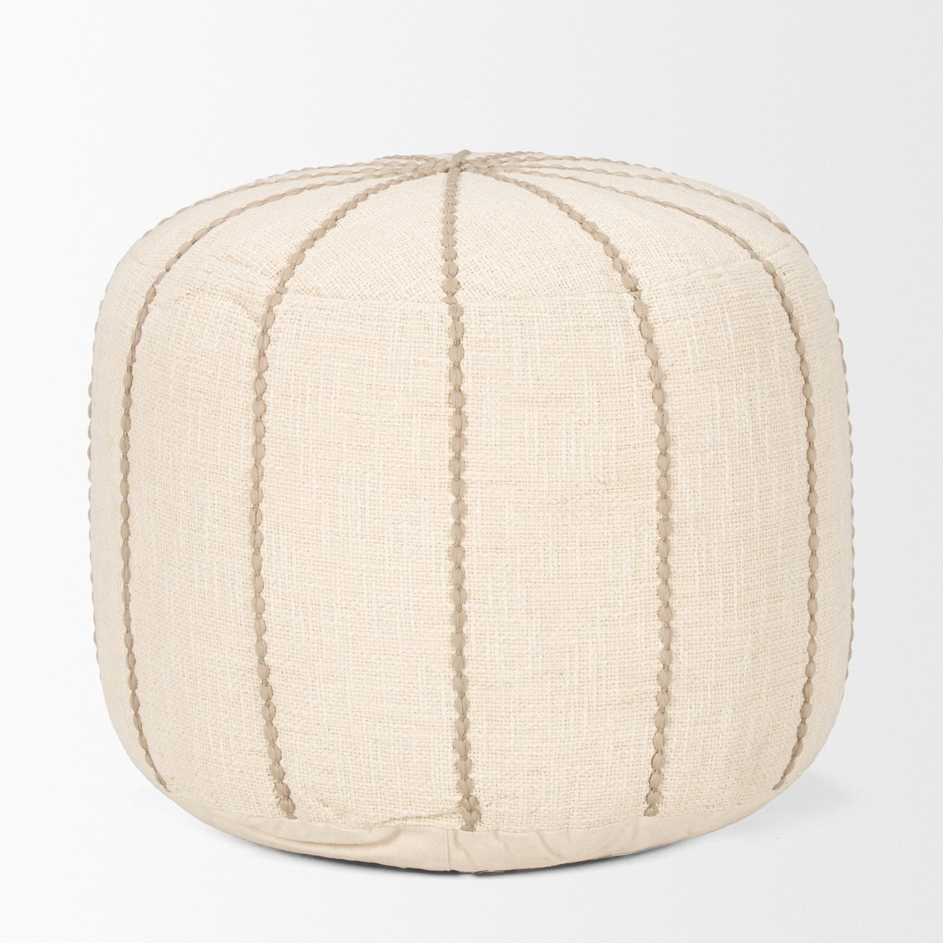 Front view of the Sachi round pouf in beige textured fabric with decorative vertical brown stitching creating a ribbed effect