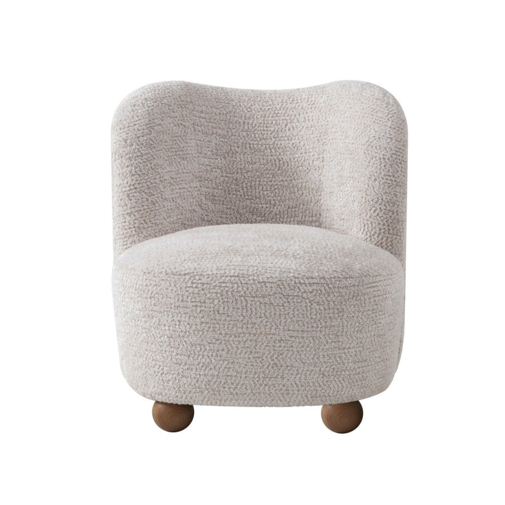 Saga Accent Chair in Oatmeal bouclé fabric featuring a rounded silhouette and wooden ball feet.