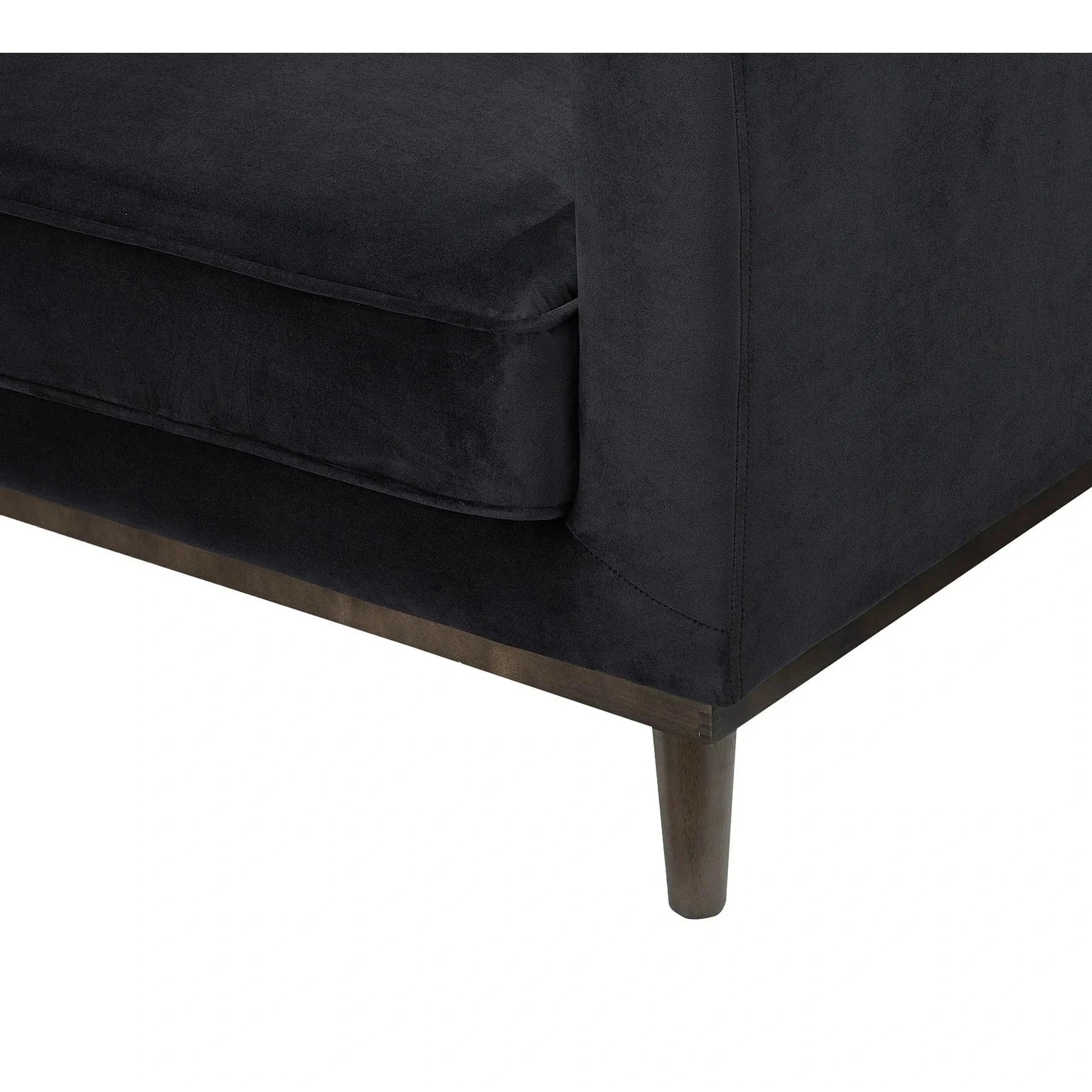 Close-up of the front corner showing the plush velvet texture and precise upholstery stitching
