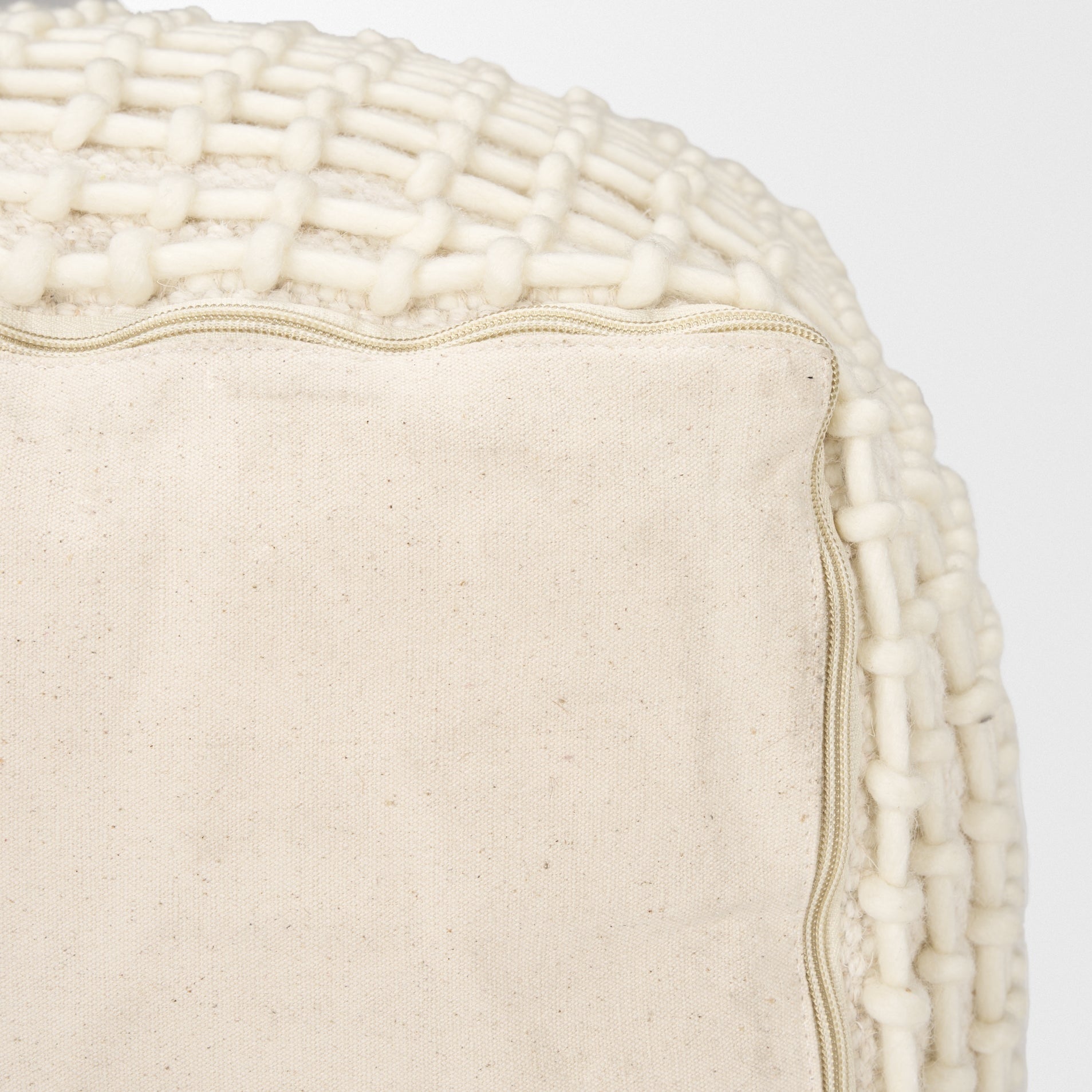 Straight-on front view showing the uniform square silhouette and consistent cream stitching across the beige surface