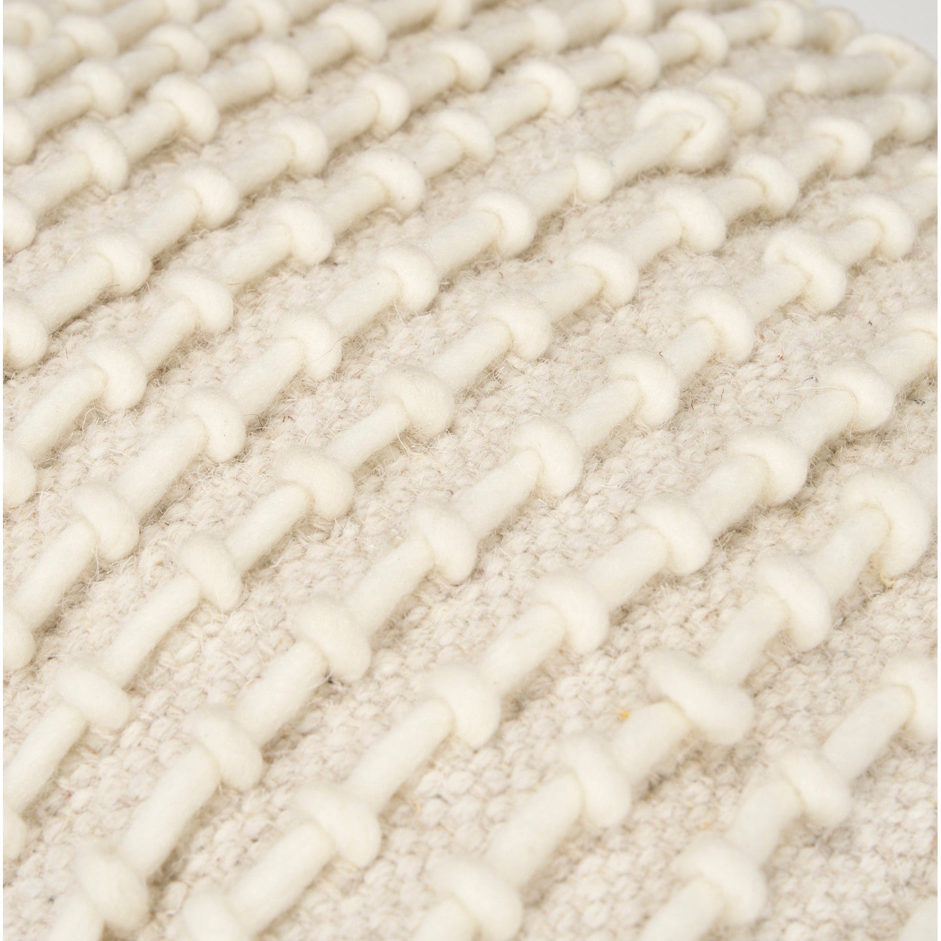 Straight-on front view showing the uniform square silhouette and consistent cream stitching across the beige surface
