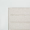 Macro shot highlighting the durable woven texture and precise corner tailoring of the upholstered headboard