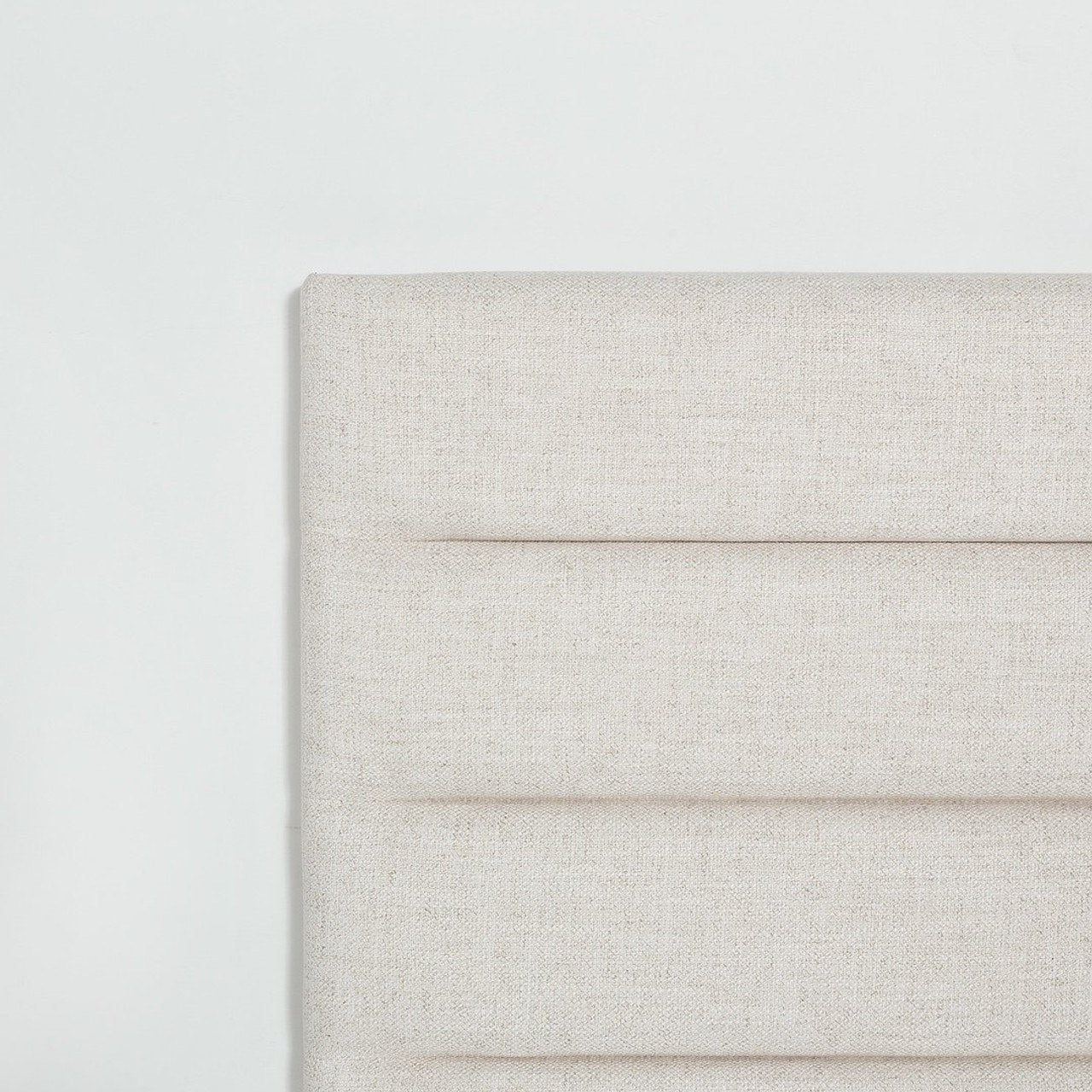 Front view of the Julia storage bed featuring a soft sand fabric and a modern horizontal channel tufted headboard