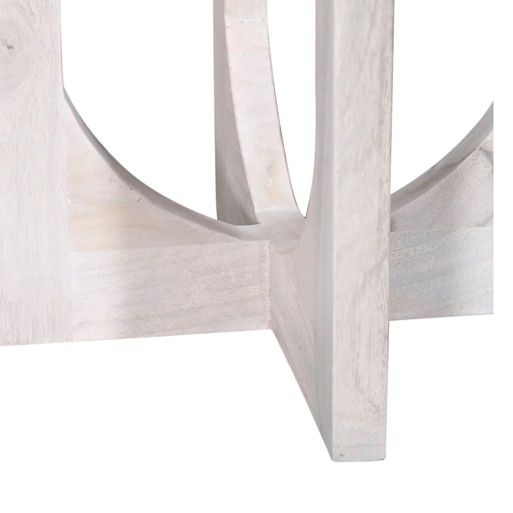 Three-quarter view of the Sasha side table featuring a circular top and an architectural pedestal base with elegant U-shaped cutouts in a light white wash finish