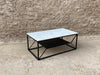 Sasha marble coffee table with black metal legs and lower shelf, modern rectangular coffee table styled in a contemporary living space