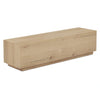 Three-quarter perspective highlighting the natural wood grain and the recessed plinth base of the Sawyer coffee table