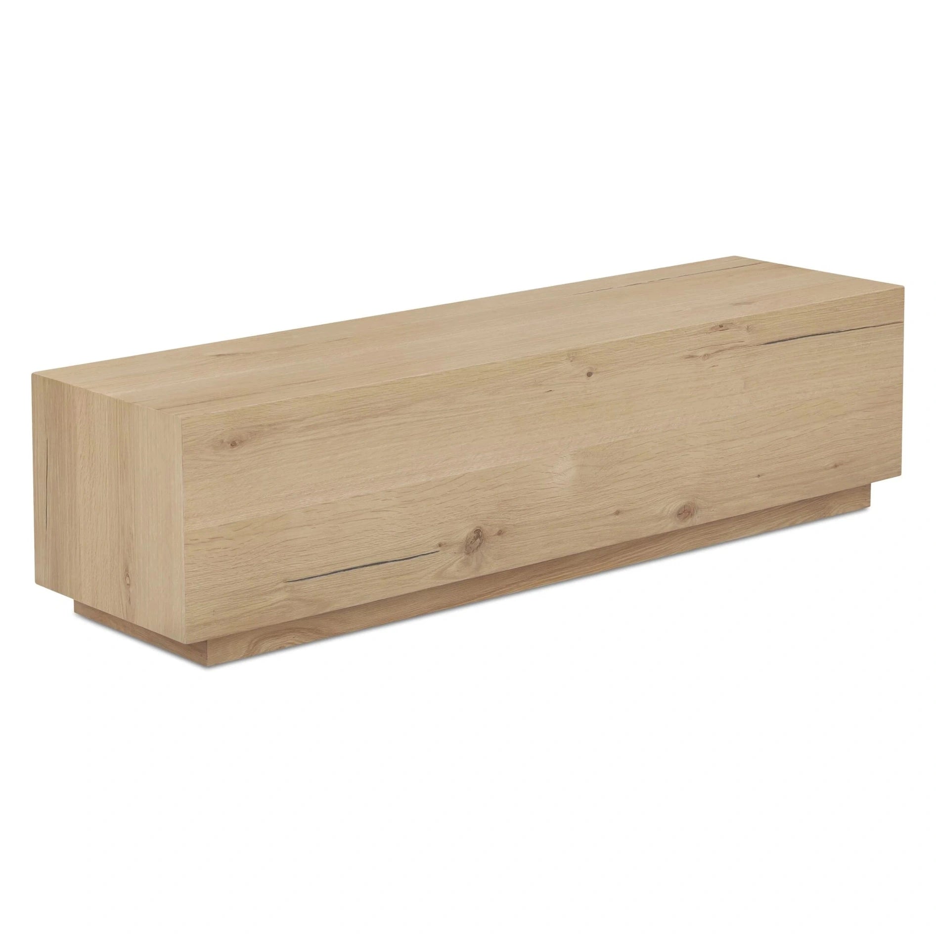 Three-quarter perspective highlighting the natural wood grain and the recessed plinth base of the Sawyer coffee table