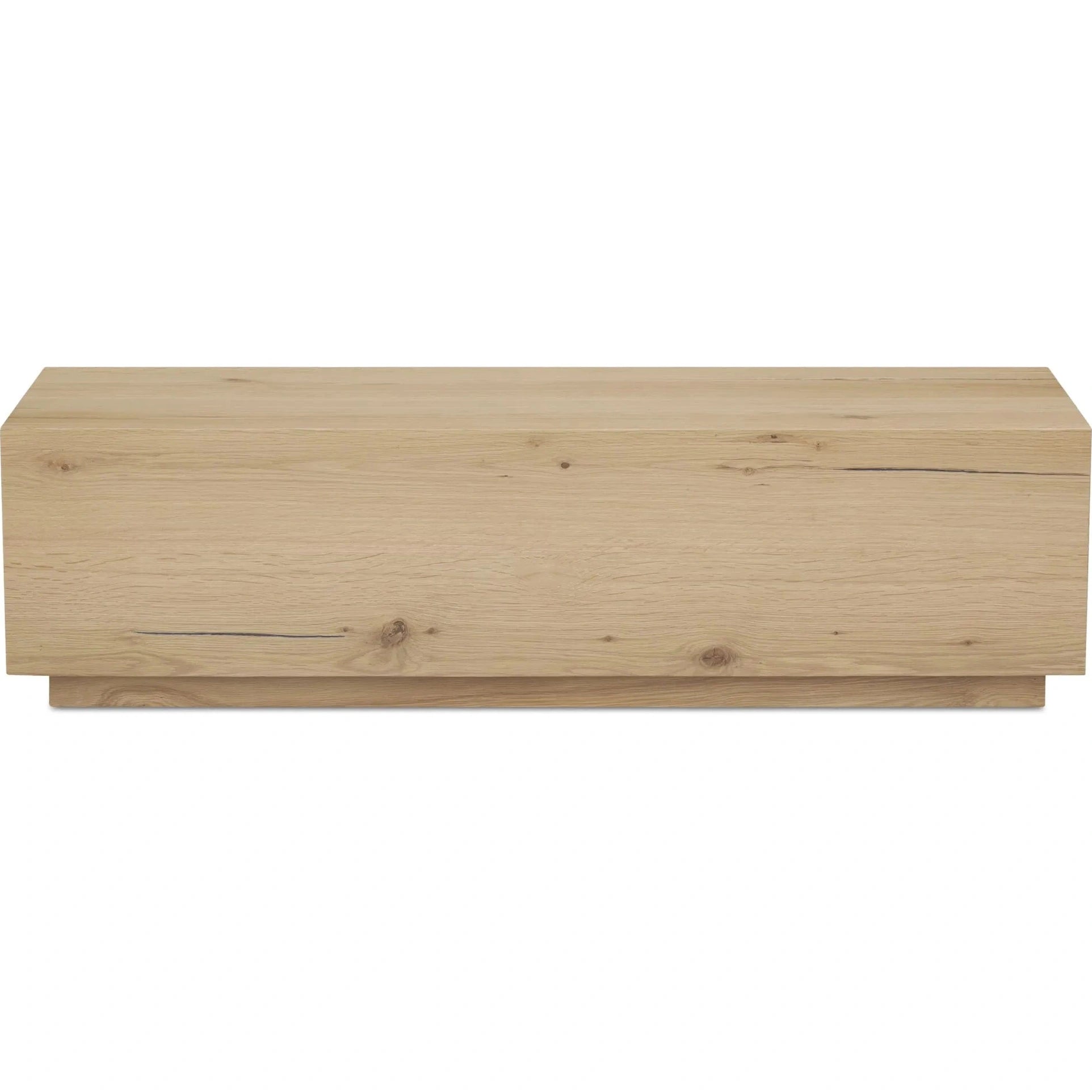 Front view of the Sawyer coffee table featuring a solid rustic oak construction with a minimalist rectangular block silhouette