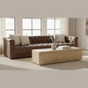 Lifestyle shot of the Sawyer rustic oak table styled in a contemporary living room with a brown tufted leather sofa