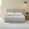 Wide lifestyle shot showing the bed positioned in a warm interior setting with modern black lighting accents