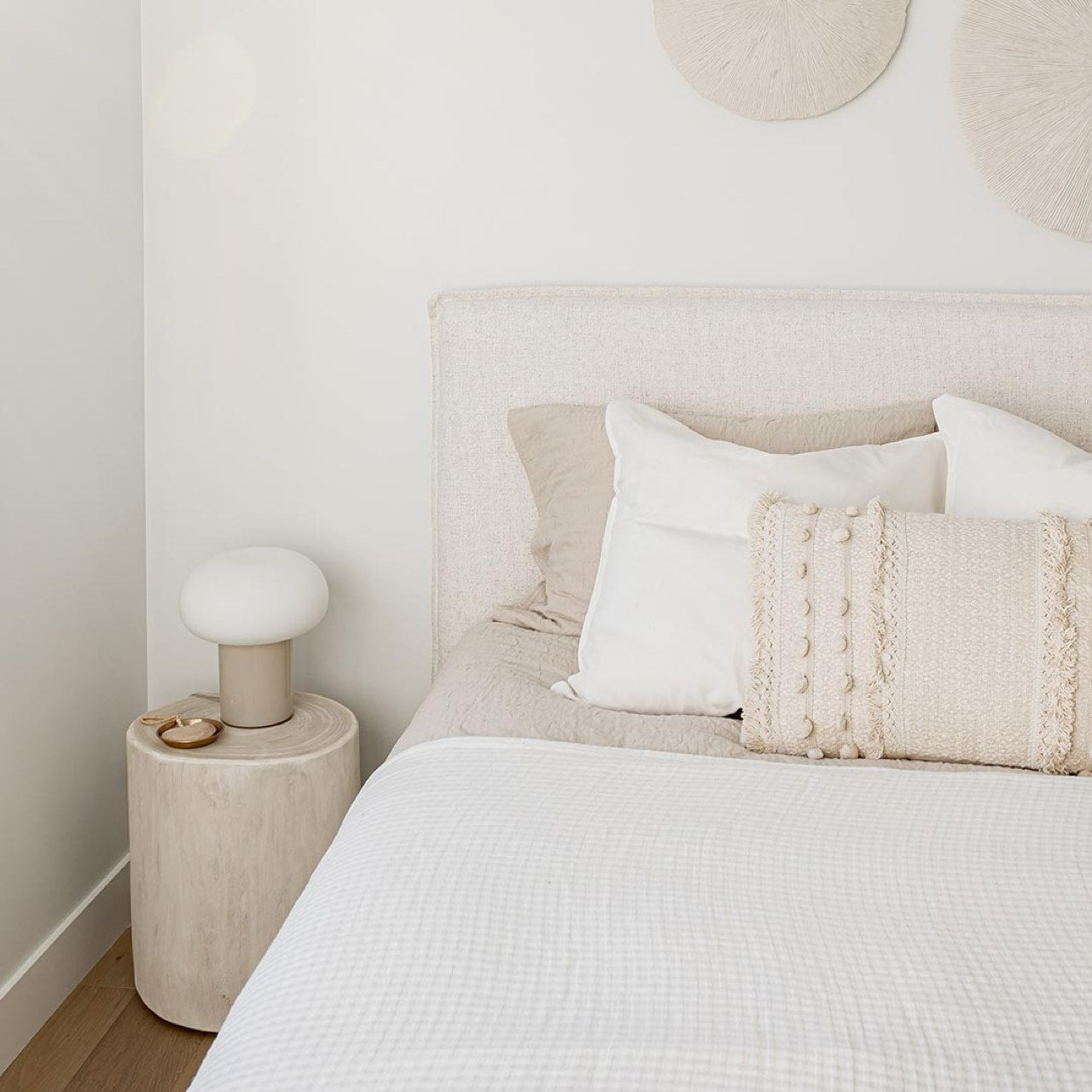 Front view highlighting the soft textured upholstery and the clean architectural lines of the bed frame
