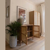 Perspective lifestyle view with cabinet doors open showcasing internal storage capacity in a modern interior