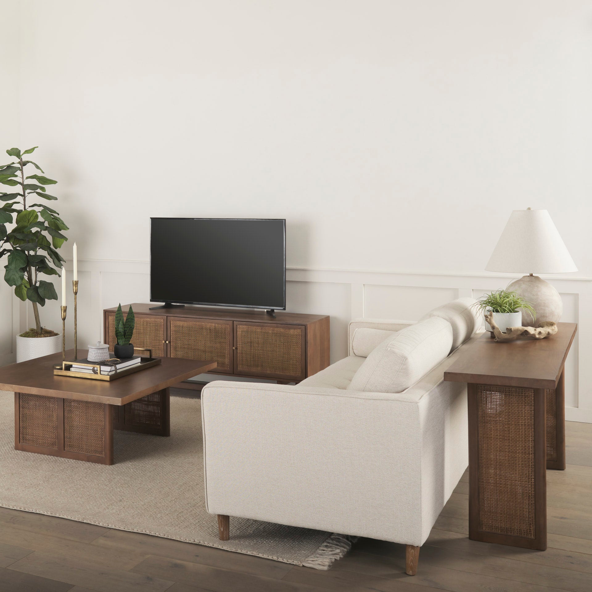 Lifestyle shot highlighting the media unit in a bright Scandinavian-inspired room with minimalist art and natural greenery