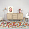 Lifestyle shot featuring the Haru sideboard styled in a bright dining space with a colorful geometric rug and decorative vases