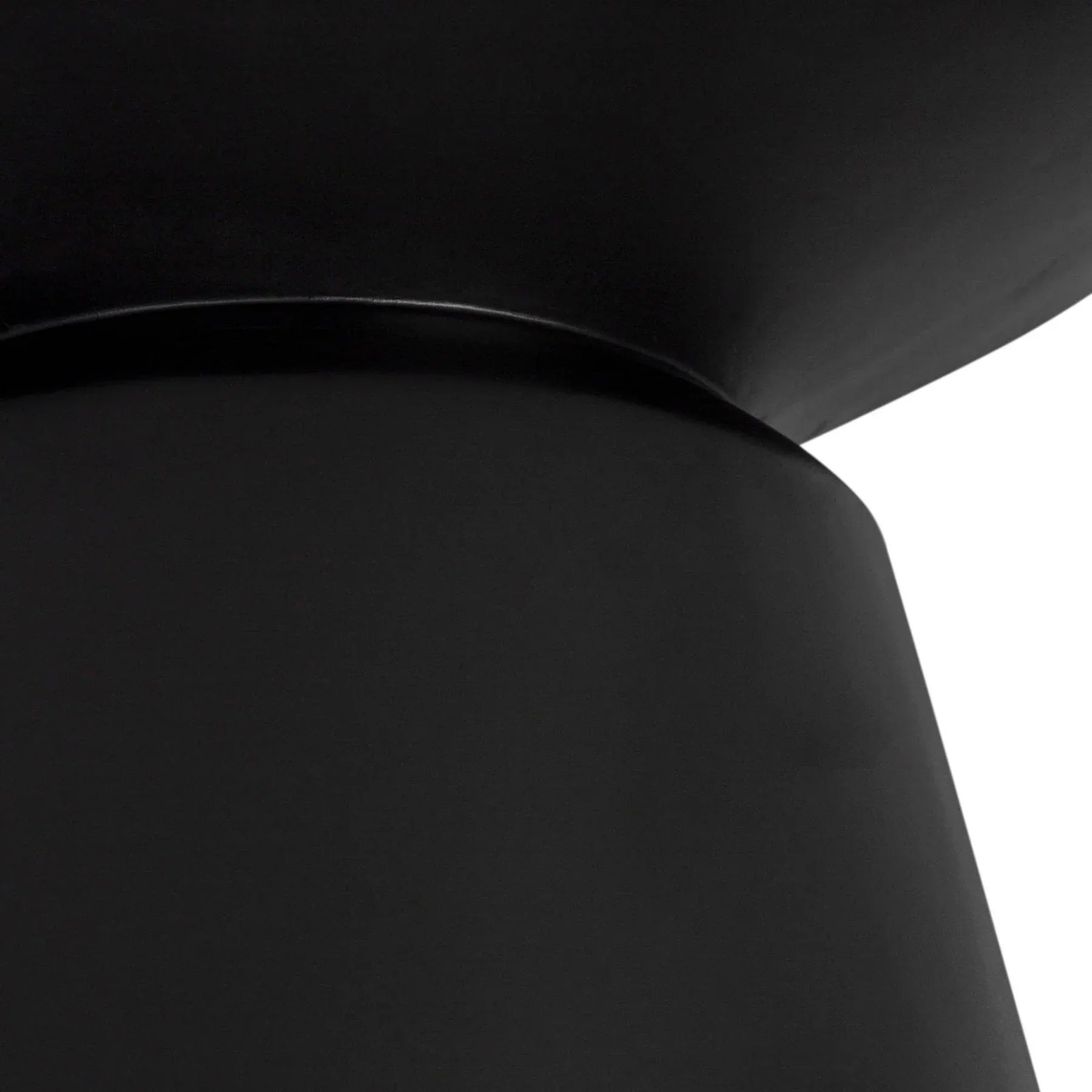 Three-quarter view of the Concrete Mineral side table featuring a matte black finish and a bold sculptural silhouette with a tapered pedestal base