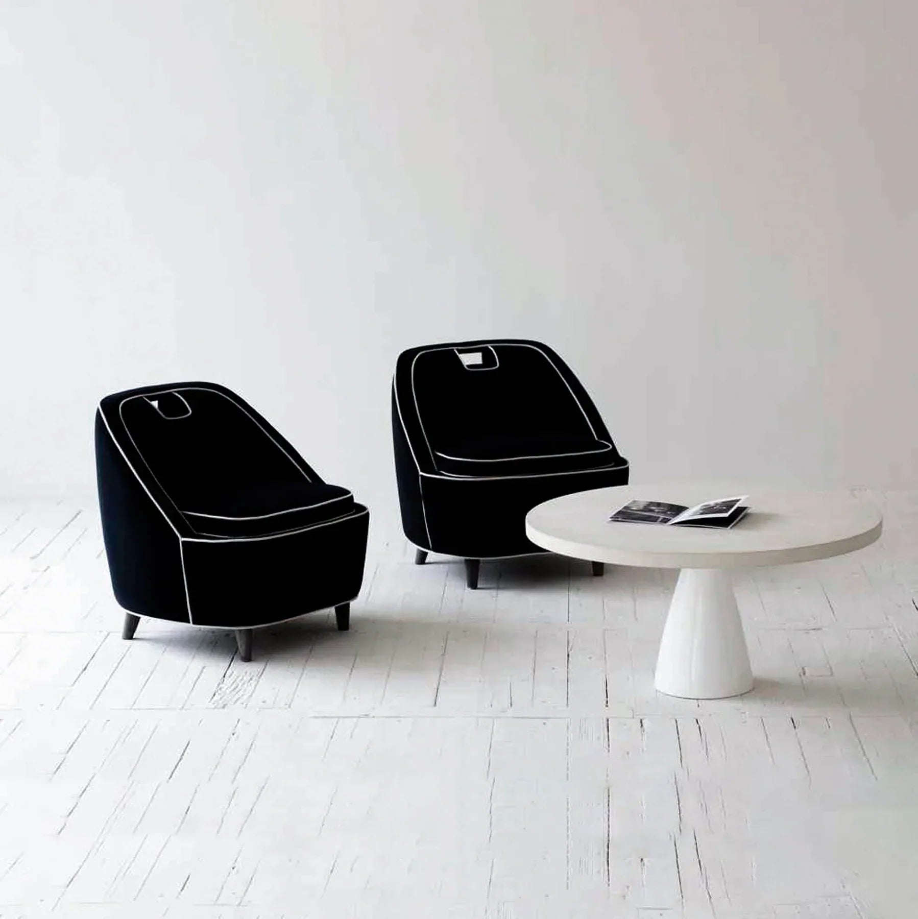 Front view of the Sculpture coffee table featuring a large circular top and a tapered conical pedestal base in a smooth white concrete finish