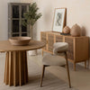 Three-quarter perspective view highlighting the architectural vertical fluting on the solid wood pedestal base