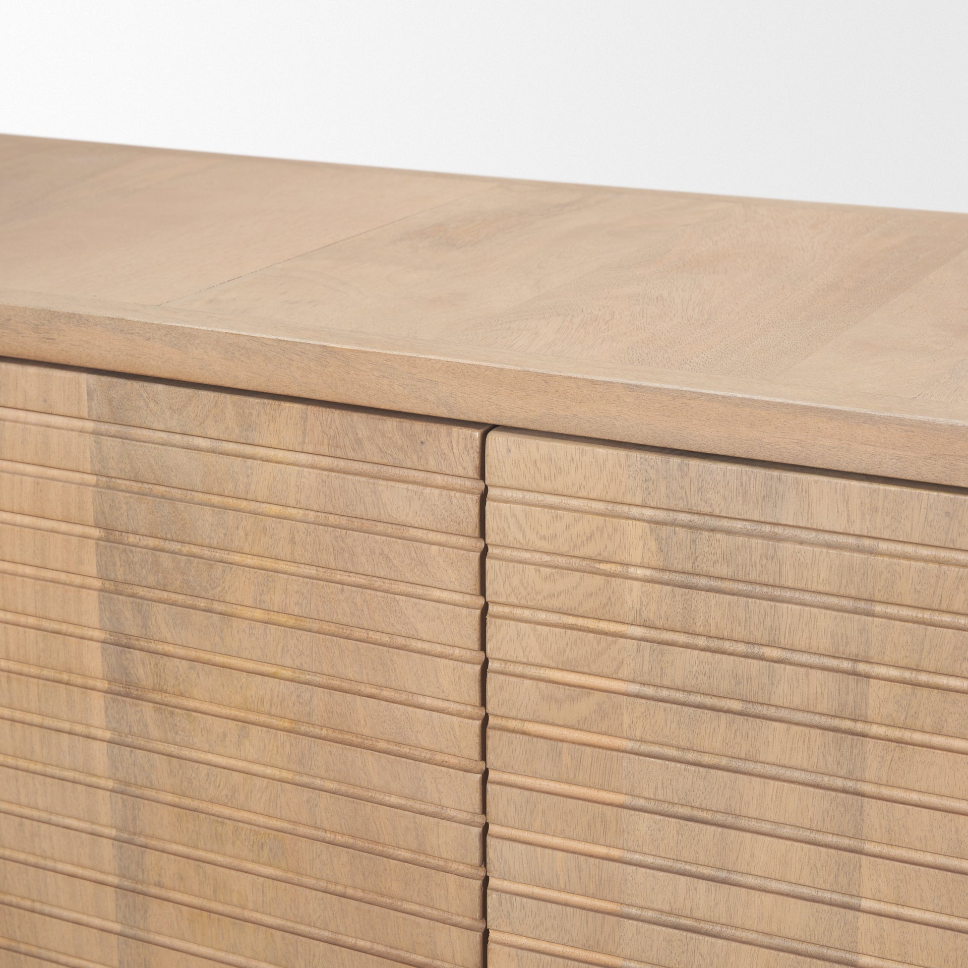 Front view of the Sorina sideboard featuring light brown wood construction with intricate reverse fluted door panels and an elegant arched base