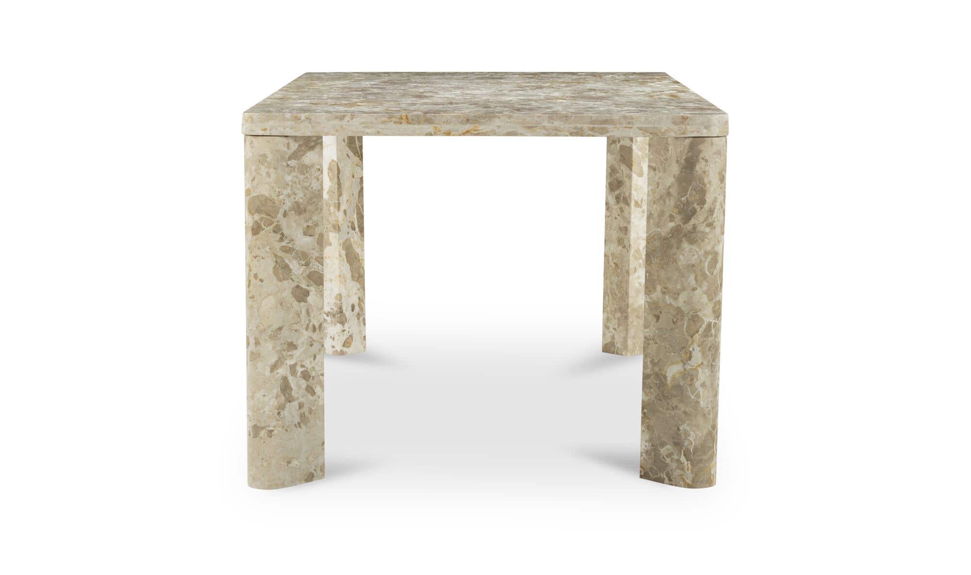 Front view of the Segment dining table in beige panther stone featuring a thick rectangular top and rounded architectural legs