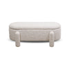 Front view of the Selva storage bench in cream textured fabric featuring an oval capsule shape and four upholstered peg legs