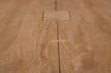 Detailed view of the tabletop highlighting the natural wood texture and artisanal butterfly joint craftsmanship