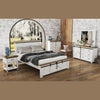 Lifestyle shot featuring the Provence bed in a rustic bedroom setting with matching white distressed case goods and a wooden arched window